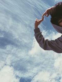 Low angle portrait of man against sky