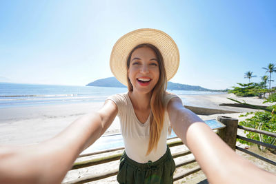 Self portrait of tourist woman smiling at camera. holidays in tropical destination.