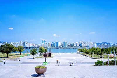 View of cityscape against blue sky