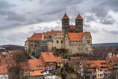 Buildings in town against sky