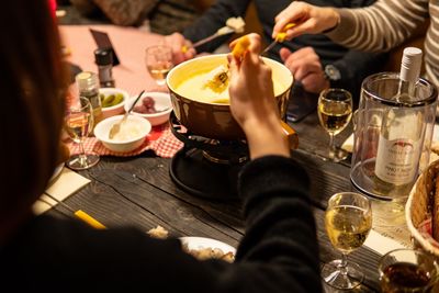 Midsection of friends having food at table