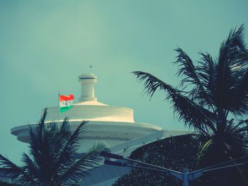 Lighthouse on beach against clear sky