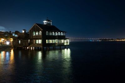 Illuminated buildings with waterfront at night