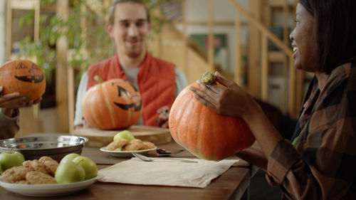 Portrait of woman holding pumpkin