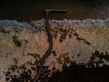 High angle view of water drops on rusty metal