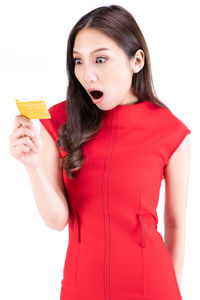Portrait of beautiful woman standing against red background