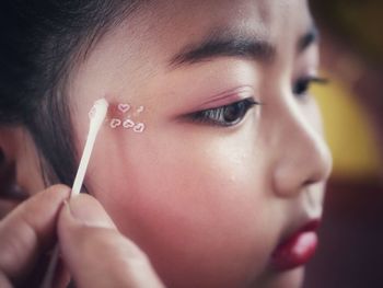 Close-up of young woman blowing nose