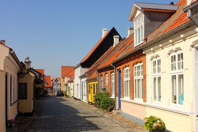 Street amidst buildings against sky