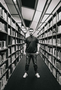 Rear view of man standing in library