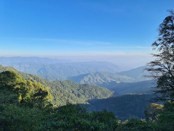 Scenic view of mountains against blue sky