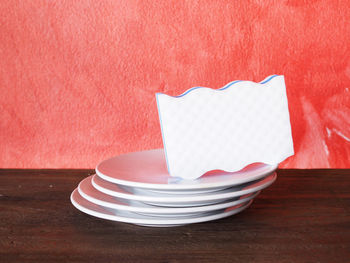 Close-up of heart shape on table against wall