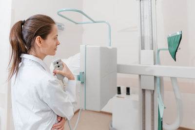 Doctor operating medical equipment in hospital