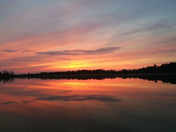 Scenic view of lake against romantic sky at sunset