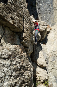Side view of woman climbing mountain