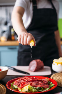 Cooking at home in kitchen italian carpaccio made from beef