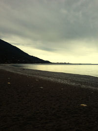 Scenic view of beach against sky during sunset