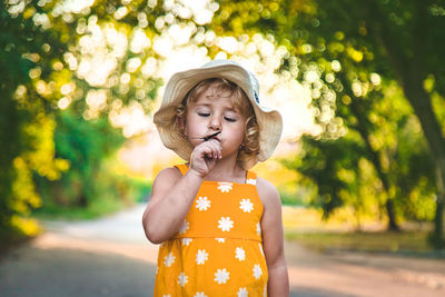Portrait of cute girl blowing bubbles in park