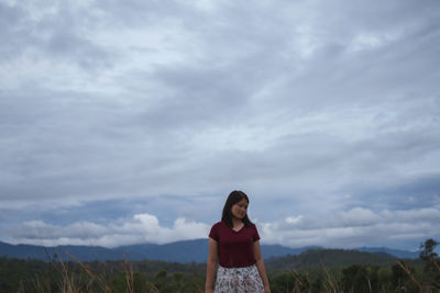 Full length of woman standing against sky