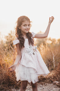 Portrait of smiling girl standing on field