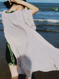 Rear view of woman standing in water