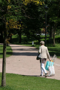 Rear view of man walking on tree