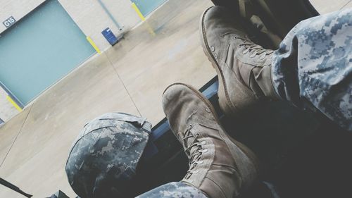 Low section of army soldier sitting in vehicle