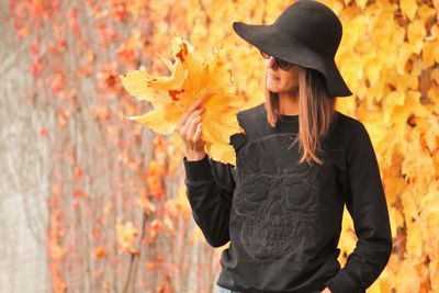 Woman holding fallen autumn leaves