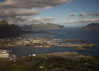 High angle view of townscape by sea against sky during sunset