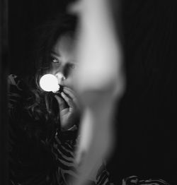 Close-up of woman holding illuminated light
