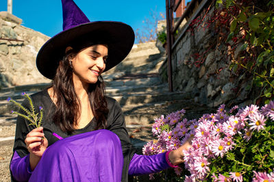 Smiling mid adult woman holding flowers