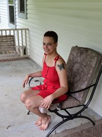 Young woman sitting at porch