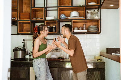 Portrait of couple standing in kitchen