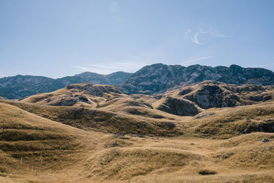 Scenic view of arid landscape against sky