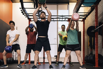 Group of beginners athletes exercising in a personal class with a private trainer. various exercises