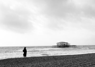 Silhouette of woman standing on beach 