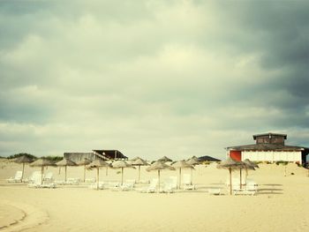 View of beach against cloudy sky