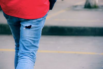 Midsection of woman wearing jeans with hole