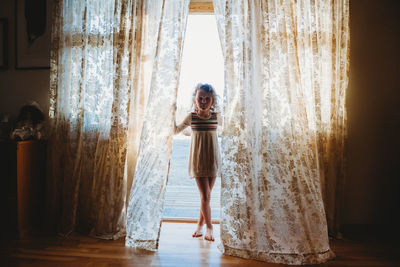 Woman standing by window