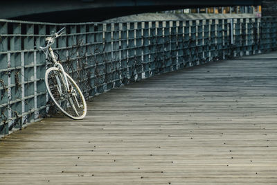 Bicycle on the pier. old white rusty bicycle park at the wooden pier.