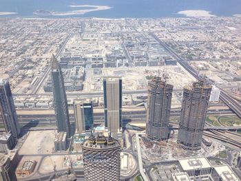 High angle view of modern buildings in city against sky