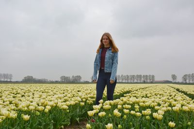 Woman standing on field against sky