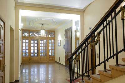 Beautiful spacious entrance a residential building with stairs and an elevator.