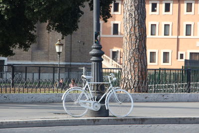 Bicycle on street against buildings in city