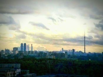 Cityscape against cloudy sky