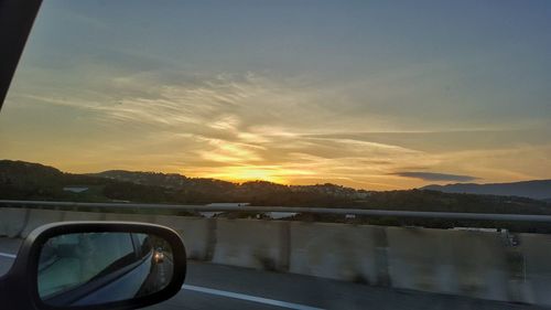 Car on road at sunset