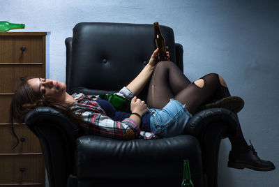 Woman sitting on sofa at home