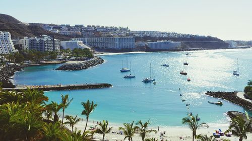Sailboats in sea against sky