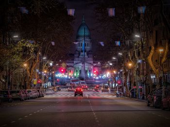 Car on road at avenida de mayo in city during night