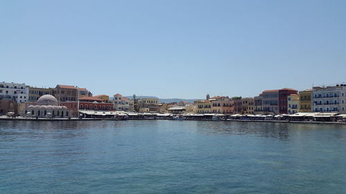 Buildings in city against clear sky