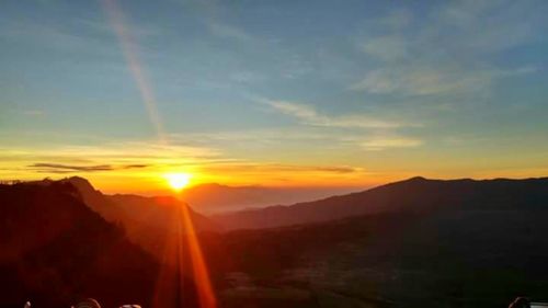 Scenic view of landscape against sky during sunset